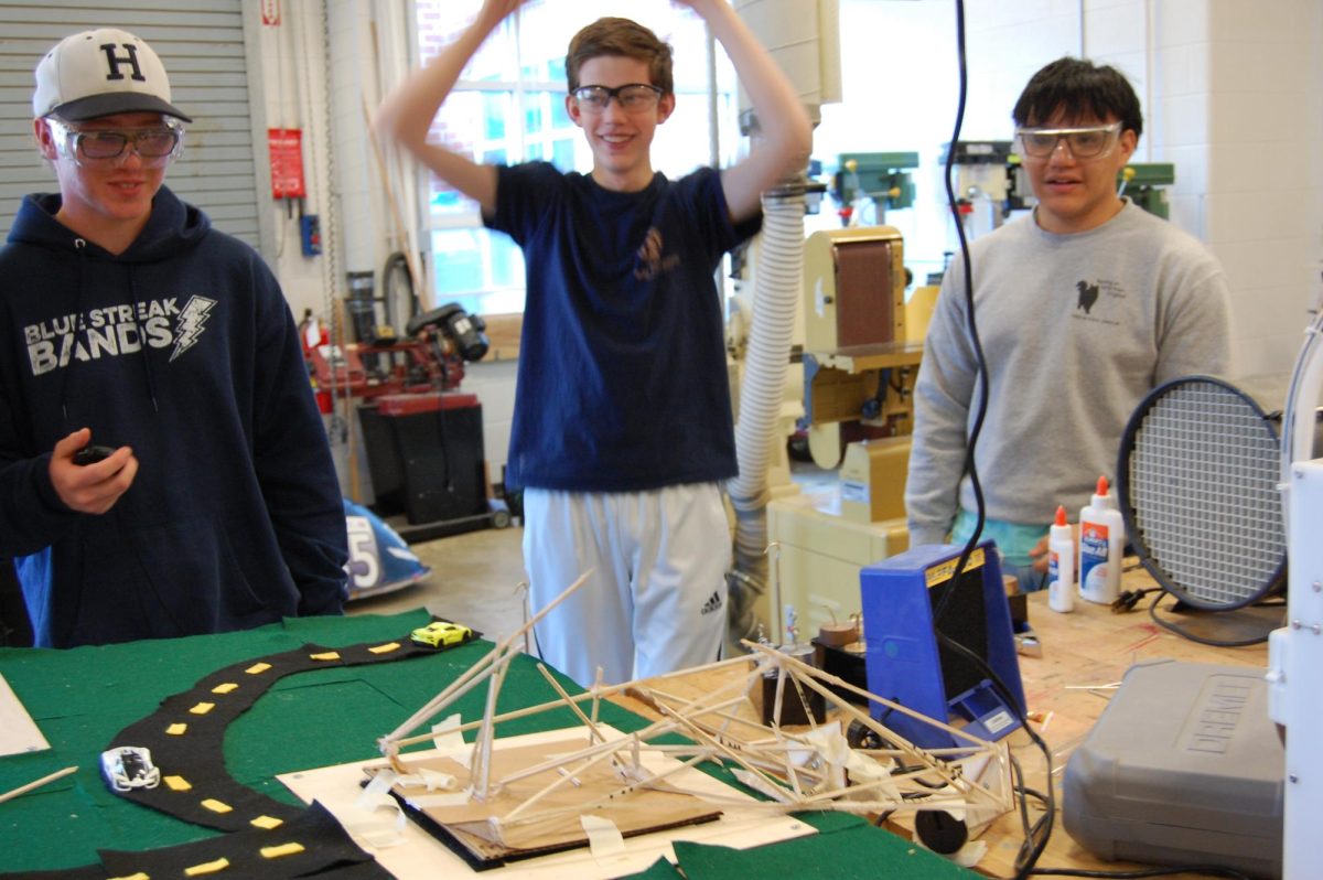 Sophomores Alex Koubek (left), Luke Snider (middle) and Teodoro Gallardo (right) celebrate as their tower finally falls collapses.