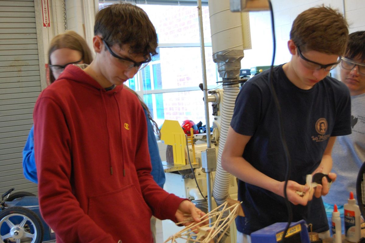 Sophomores Adrian Kreider (left) and Luke Snider (right) pick up the pieces of their fallen tower.