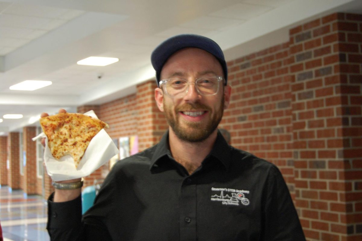 STEM Chemistry teacher, Erich Sneller enjoys his pizza.