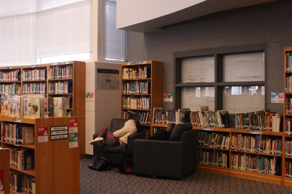 Students reading books in the library during lunch.
