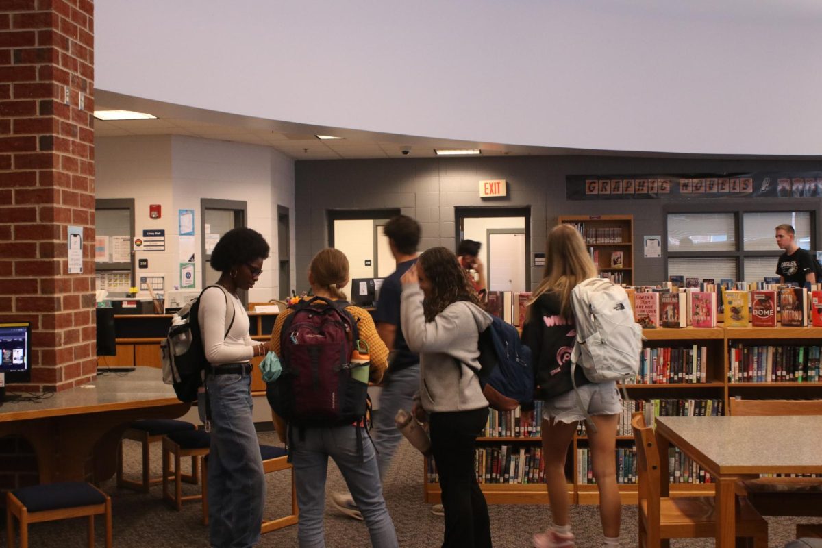 Class leaving the library after checking out books.