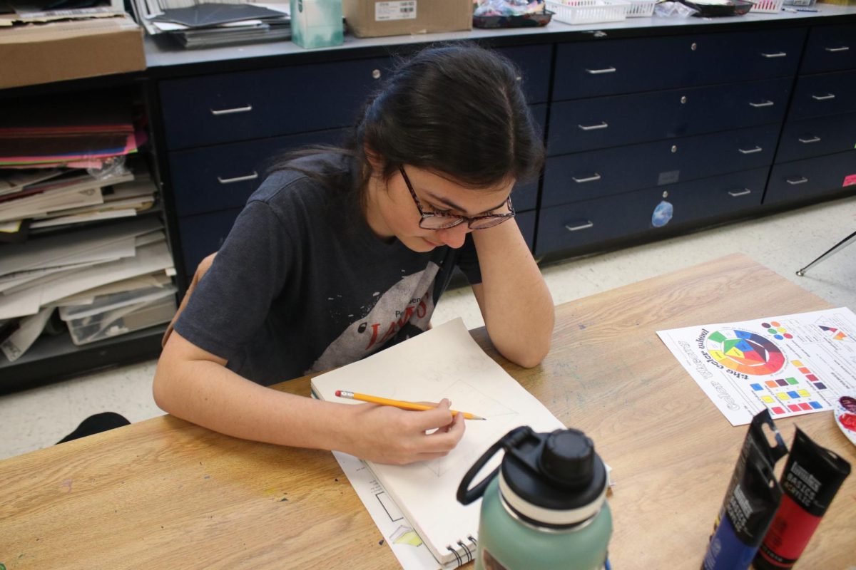 Student coming up with ideas to draw.