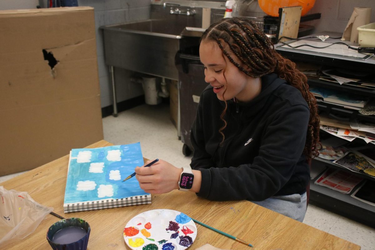 Sophomore Ah-Ghia Jones painting for art class. 