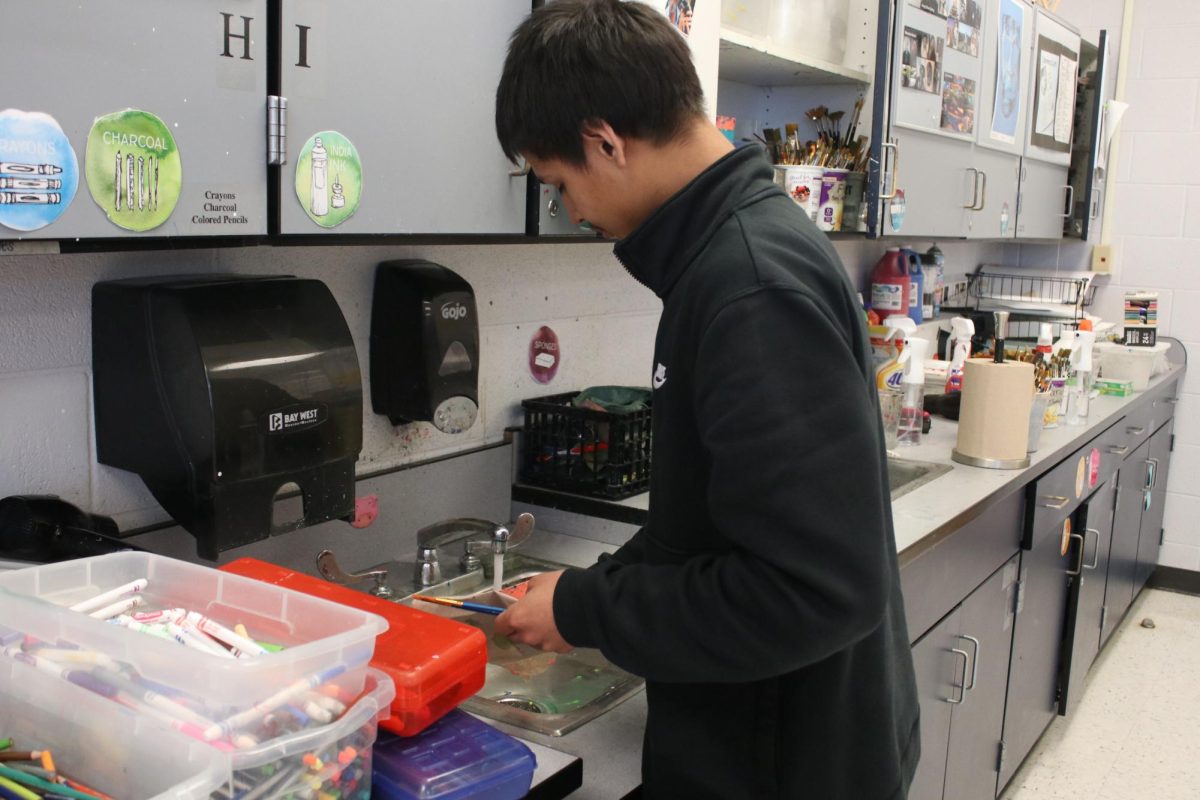 Student washing their hands for art class. 