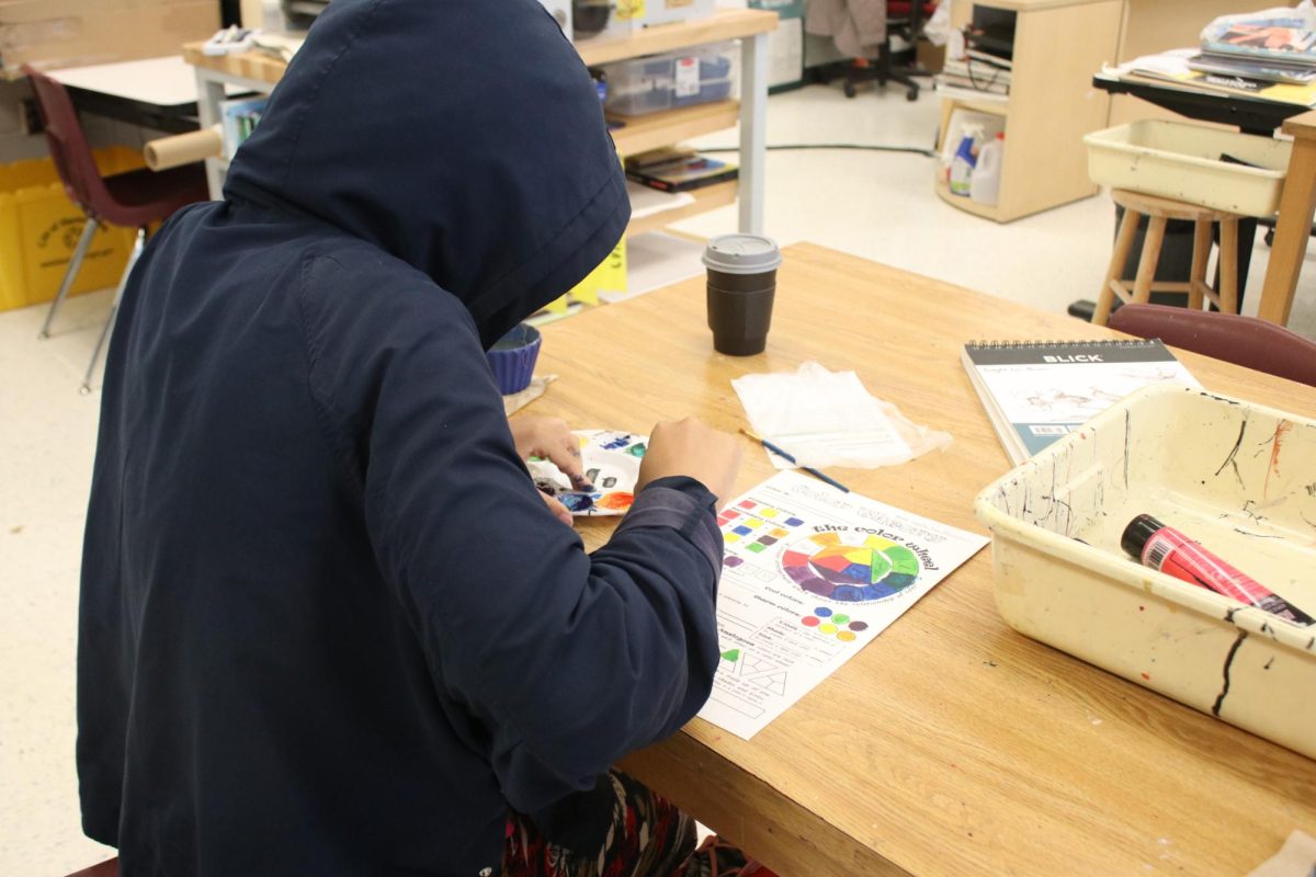 Student making color palette for art class. 