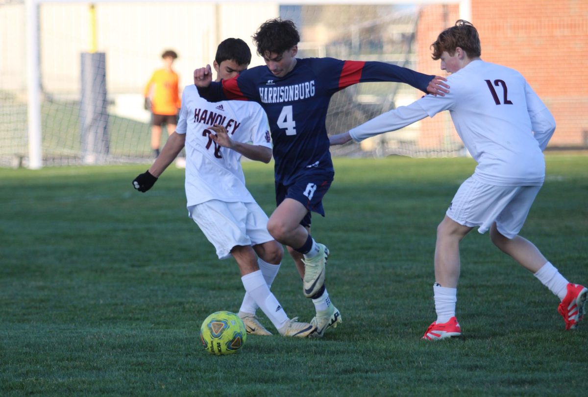 Freshman Silas Long blocks the defenders.