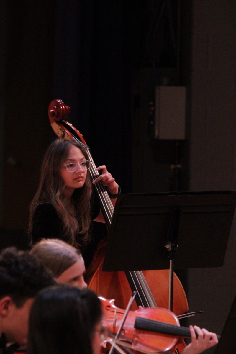 Ava Thompson playing the bass.