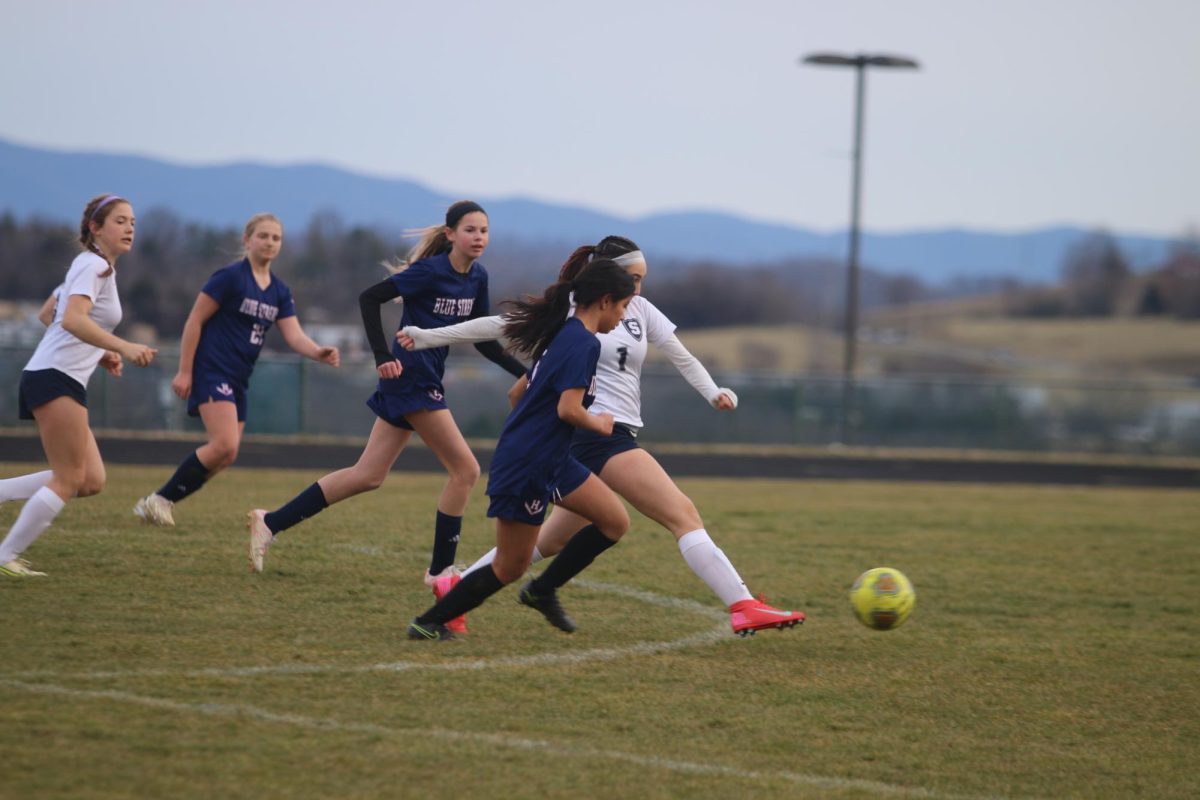 Freshman Adamari Soto Huerta chases the ball with her teammates close behind her. 