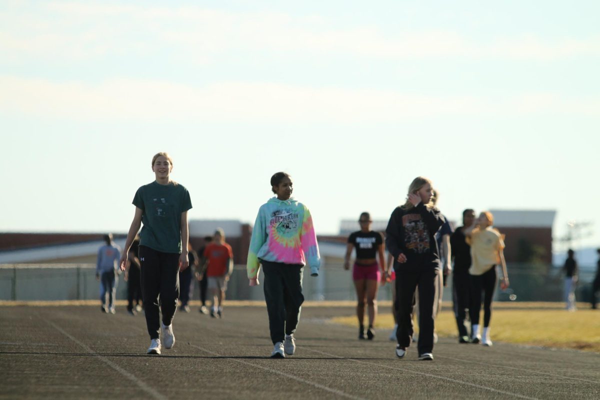 Track athletes walking after the 150 meter dash. Freshman Maren Bert says track is hard but fun. "Its tough, but its cool to connect with others that like to run," Bert said. 