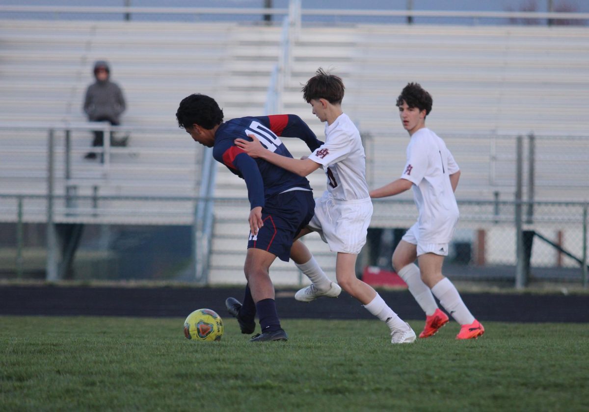 Freshman Alfredo Rivero-Rodriguez tries to get the ball away from defense.