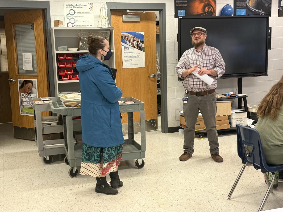 Robotics club teachers discuss about the club