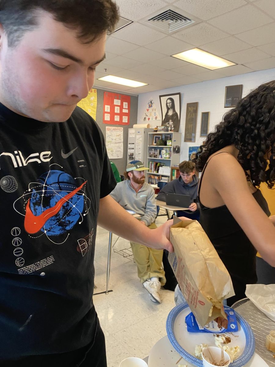 Sophomore Jack Powers pours popcorn onto his plate.