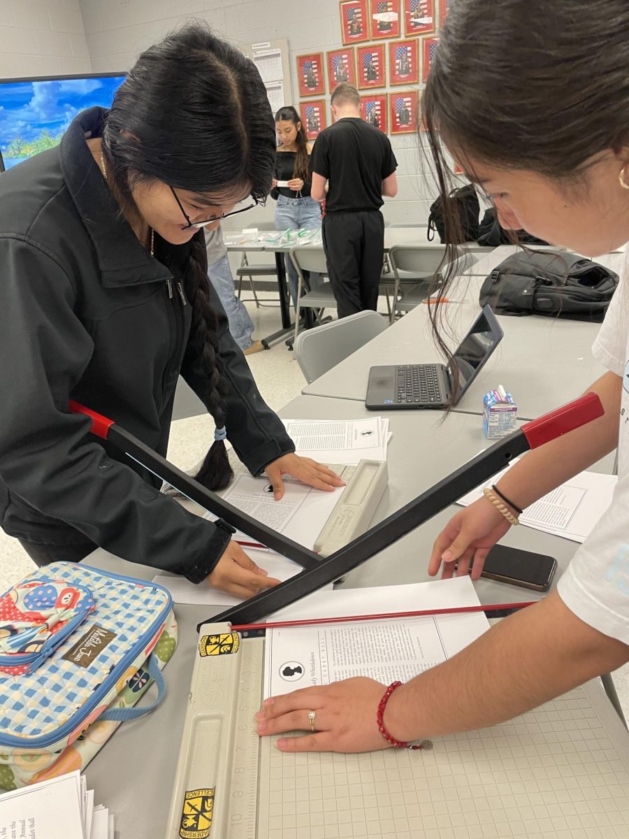 Sophomore kytzia Diaz and Elizabeth Santiago cut out the papers with paper cutter