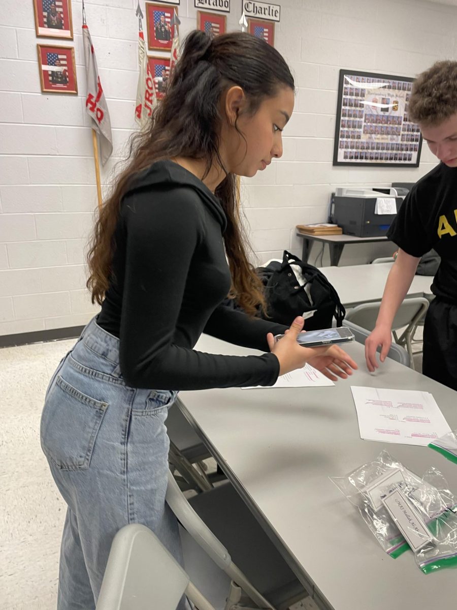 Junior Amy Matamoros helps out with teaching younger cadet 