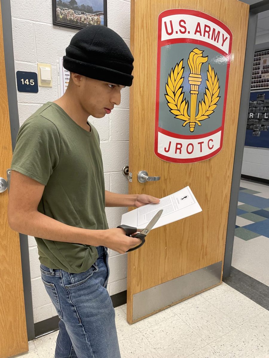 Sophomore chris Alvarado throws away extra paper