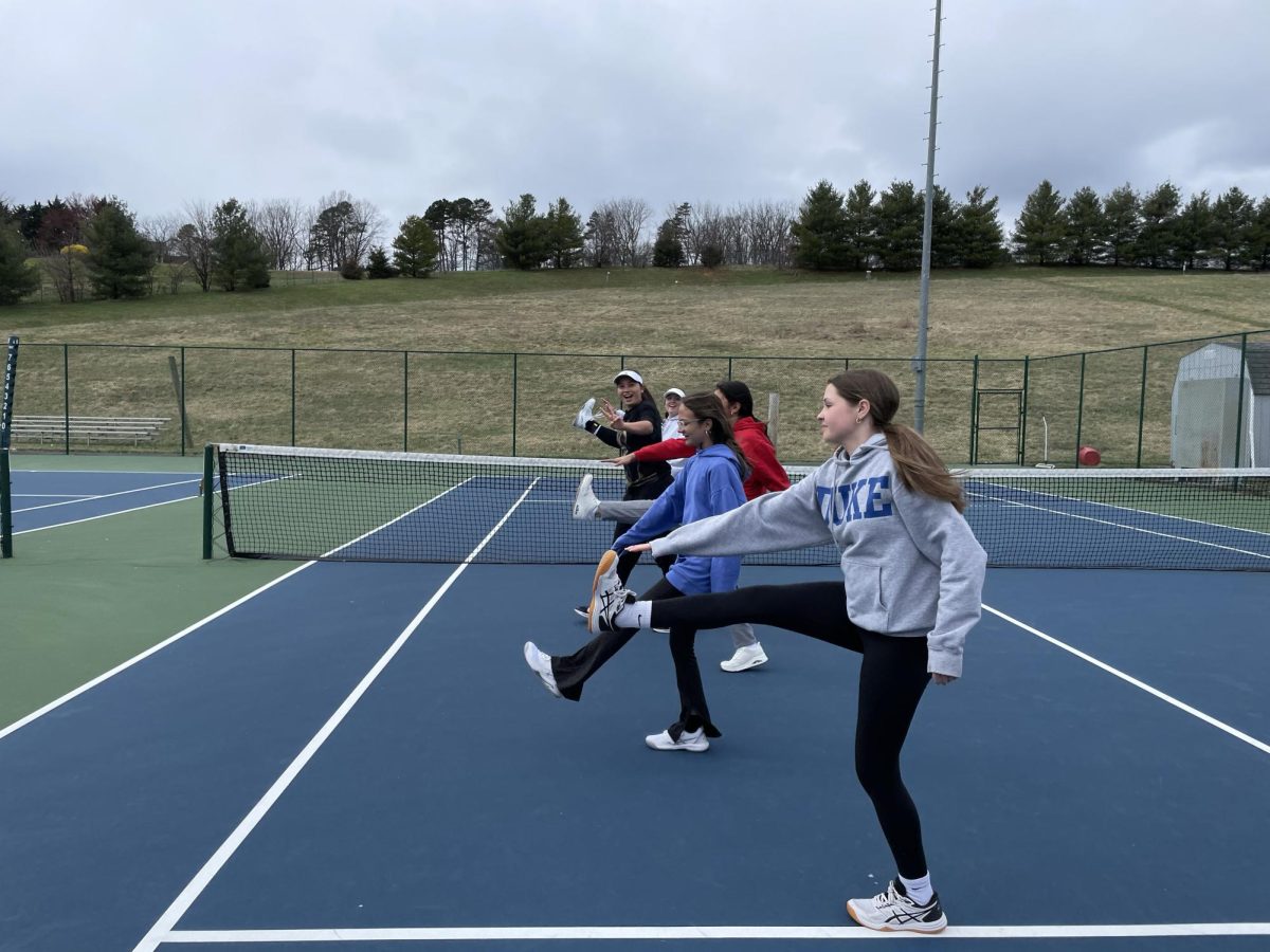Tennis players warm up before practice. 