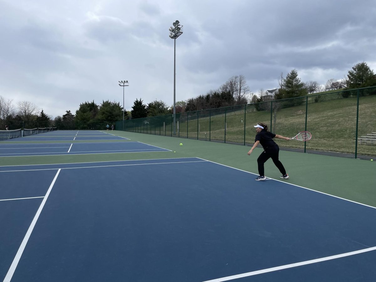 Junior Milana Utekeyeua practices hitting with her forehand. 