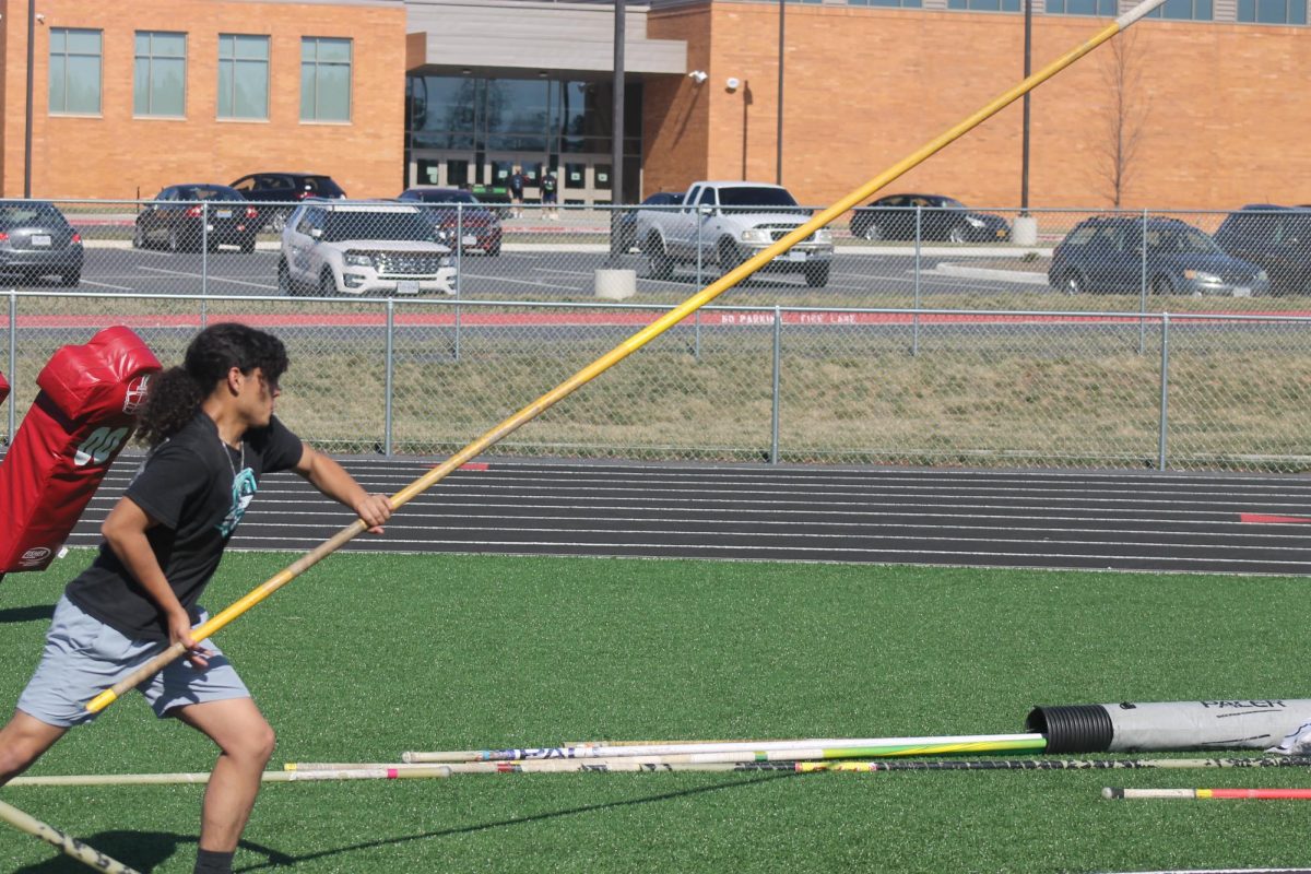 Senior Dominique practices pole vault.