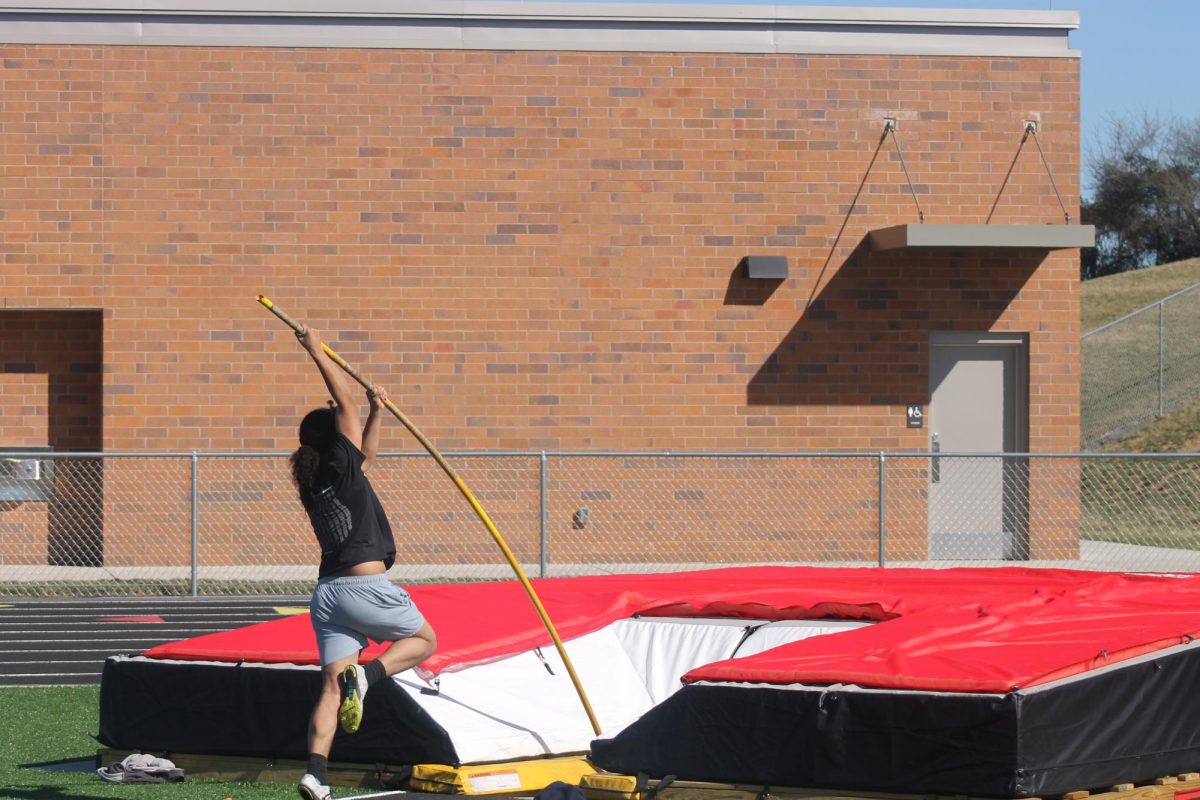 Senior track athlete Dominique practicing pole vault.