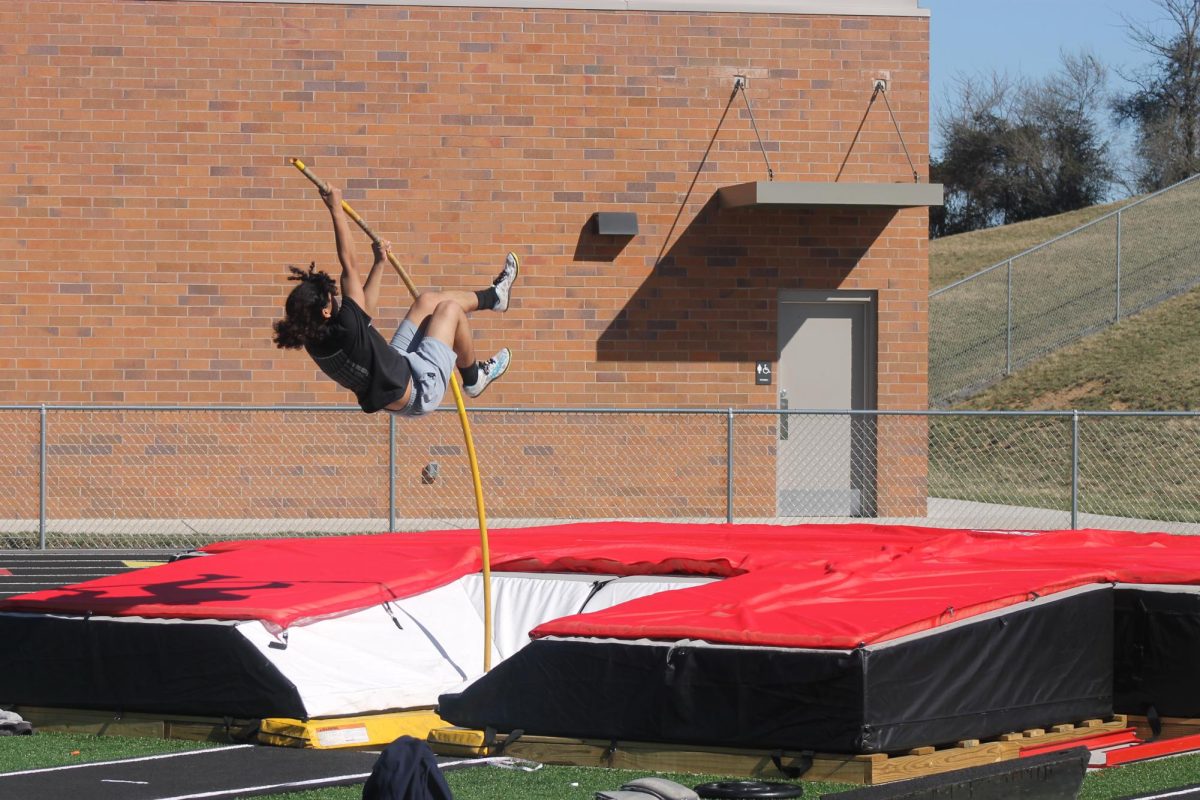Senior track athlete Dominique practicing pole vault.