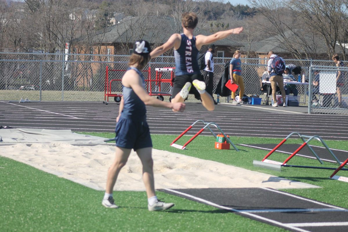 Senior track athlete Lucas practicing long jump