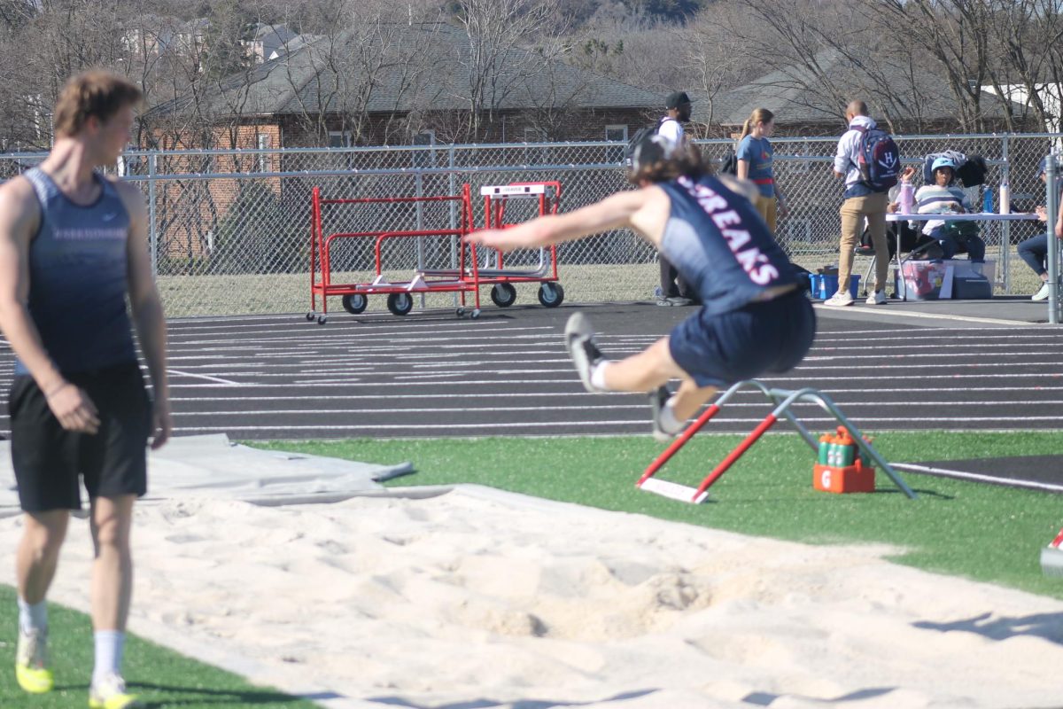 Junior Josiah practices long jump.