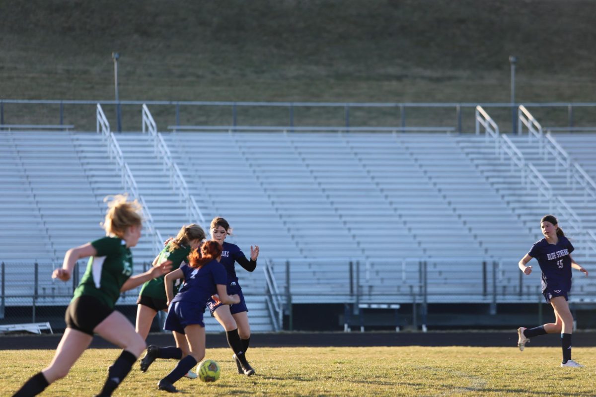 Soccer players play defense. 