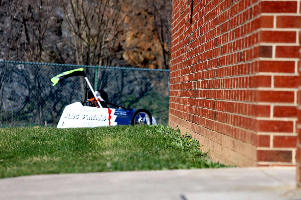 The EV car flies around the corner of HHS with Elio Cortina at the wheel.