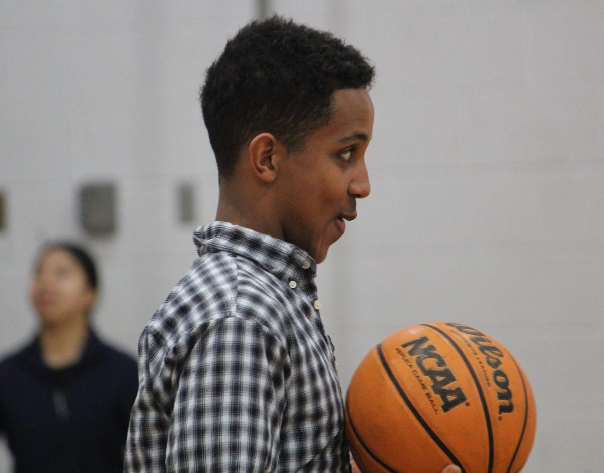Junior Hosea Tesfamariam plays basketball with friends