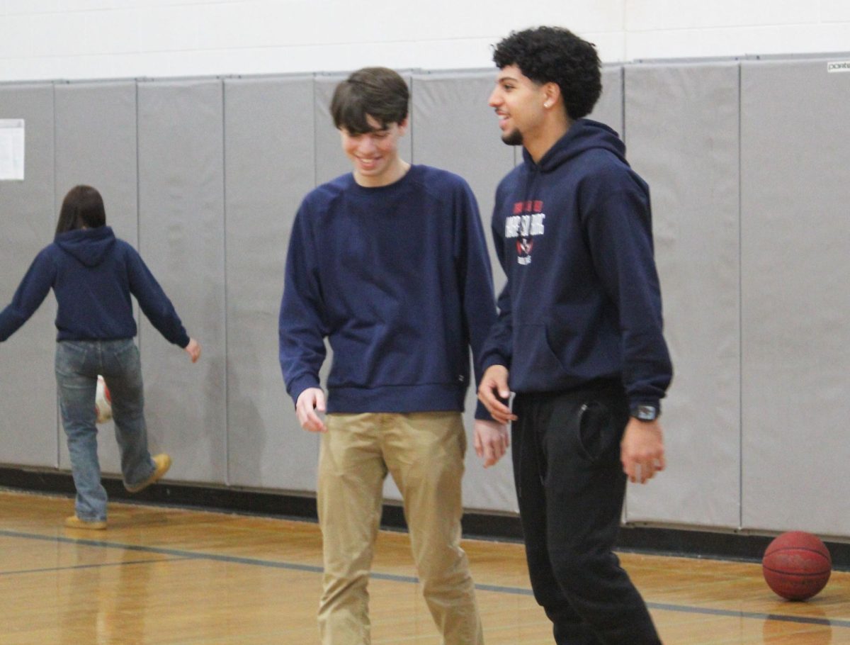 Senior Filipo Toelau and freshman Moustafa Majdoub talk while playing basketball