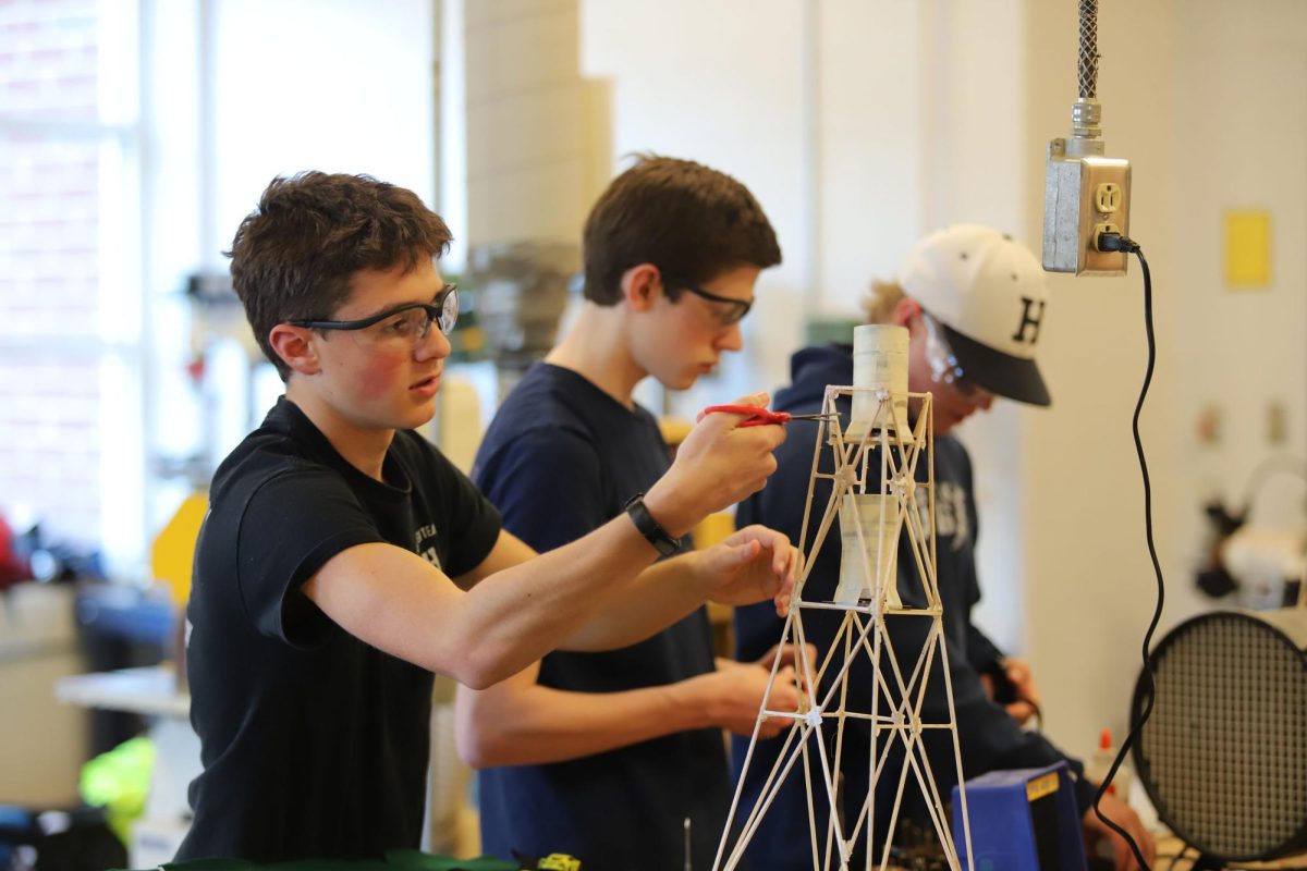 Sophomore Josiah Nafziger secures the weights to his tower in preparation for his last test.
