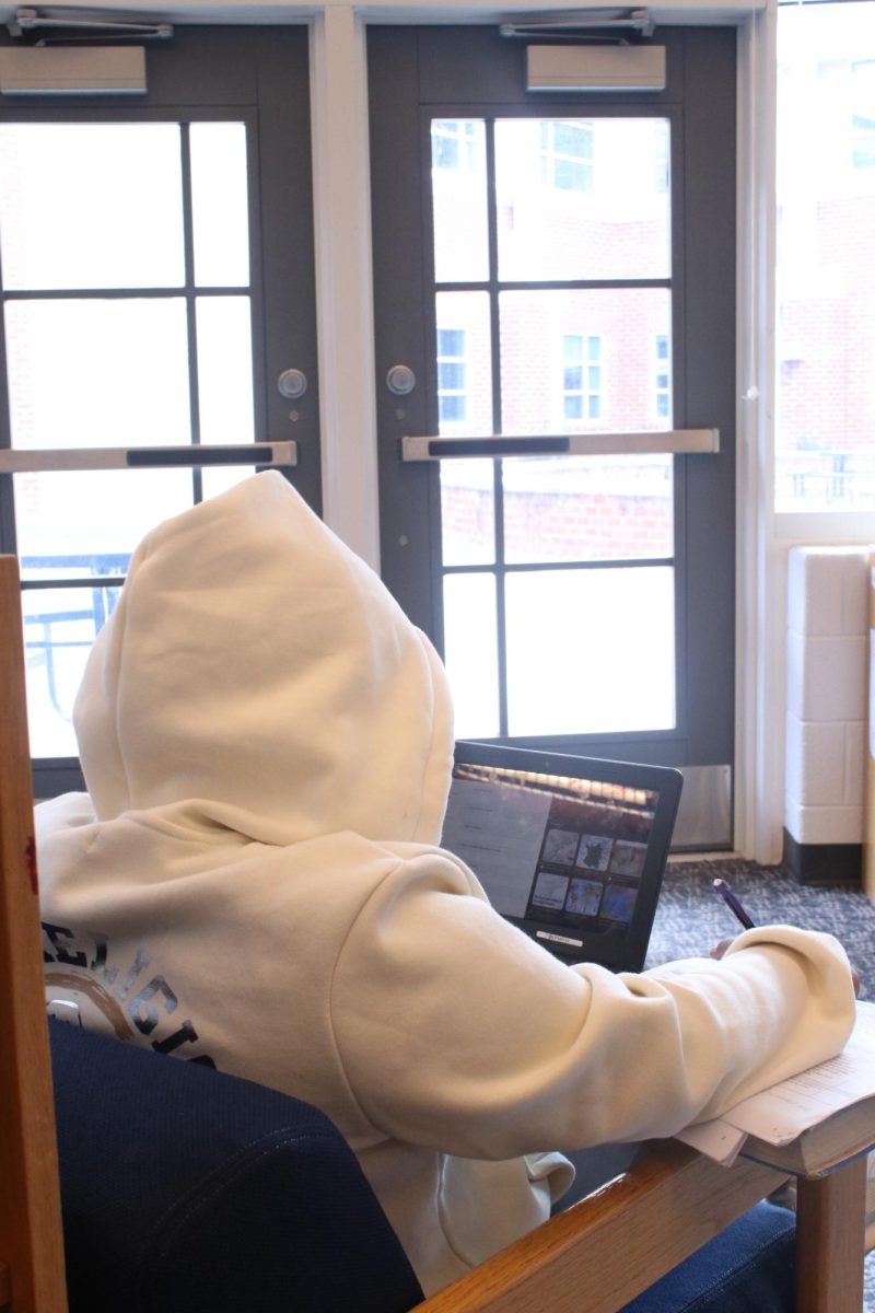 Student doing homework during lunch.