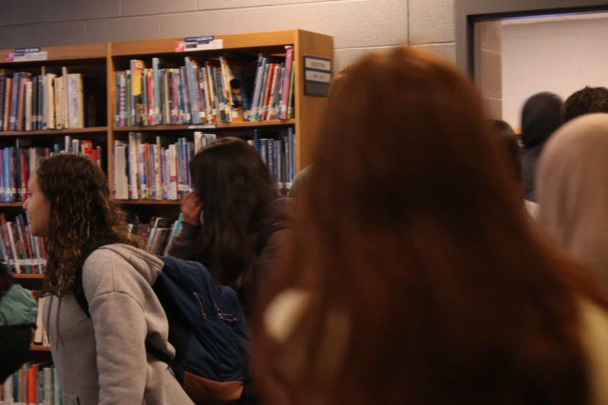 Students walking out of a classroom in the library.