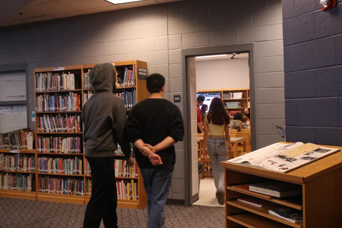 Junior Gabriel Sabarre walking into a library class.
