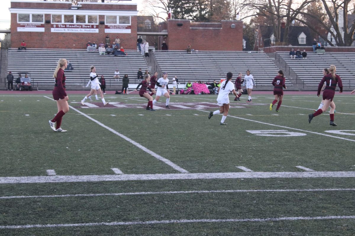 Girls chasing after the ball