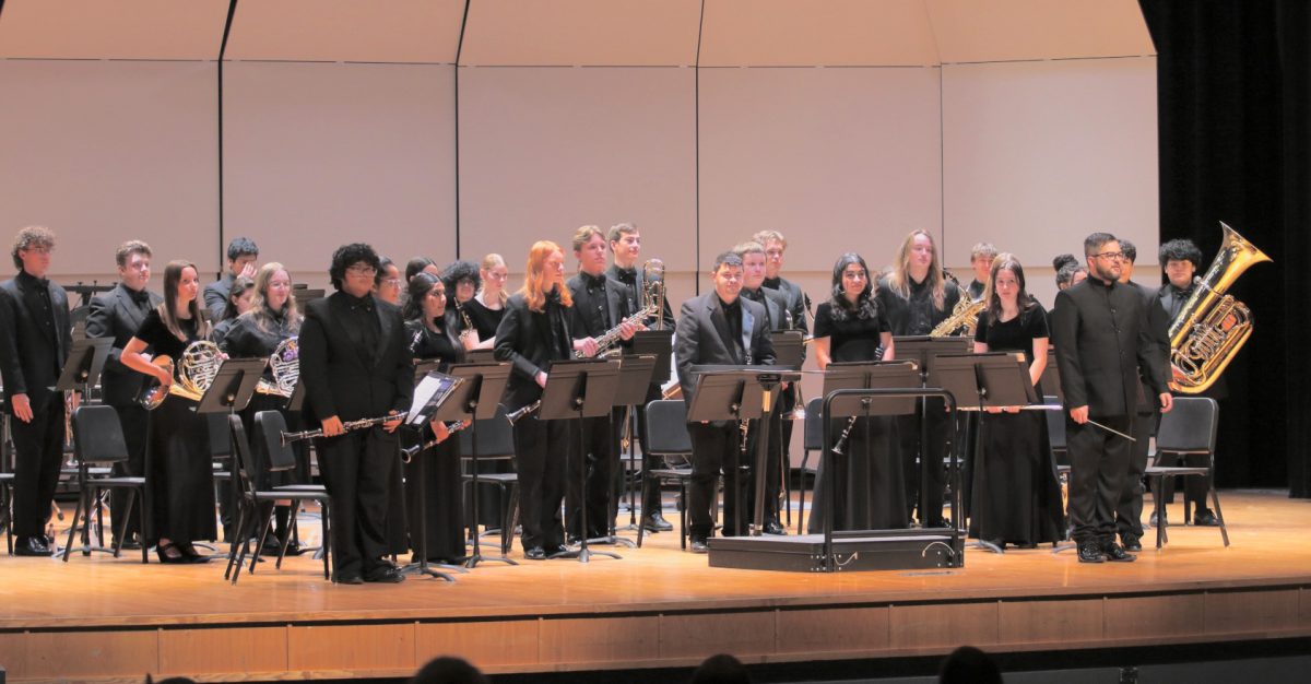 Concert band stands after performing at assessment. 