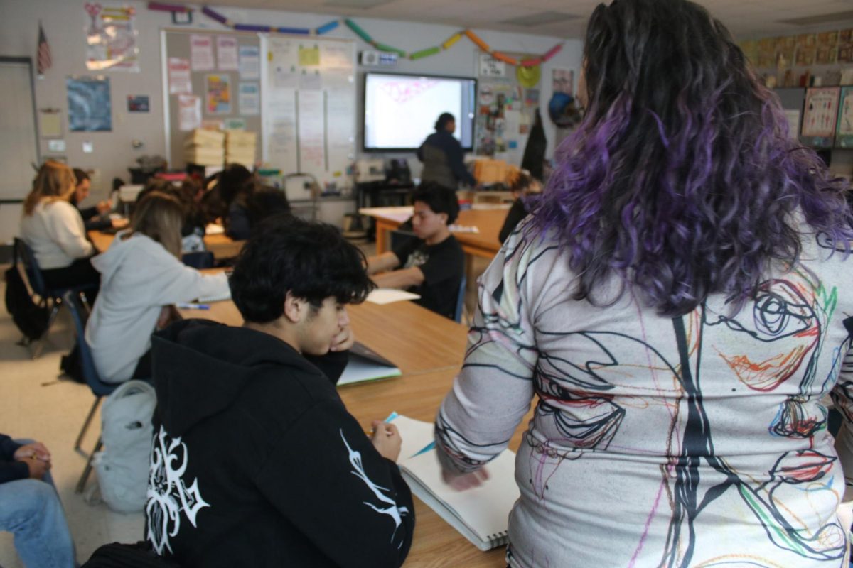 MS KELLEY EXPLAINING TO A STUDENT