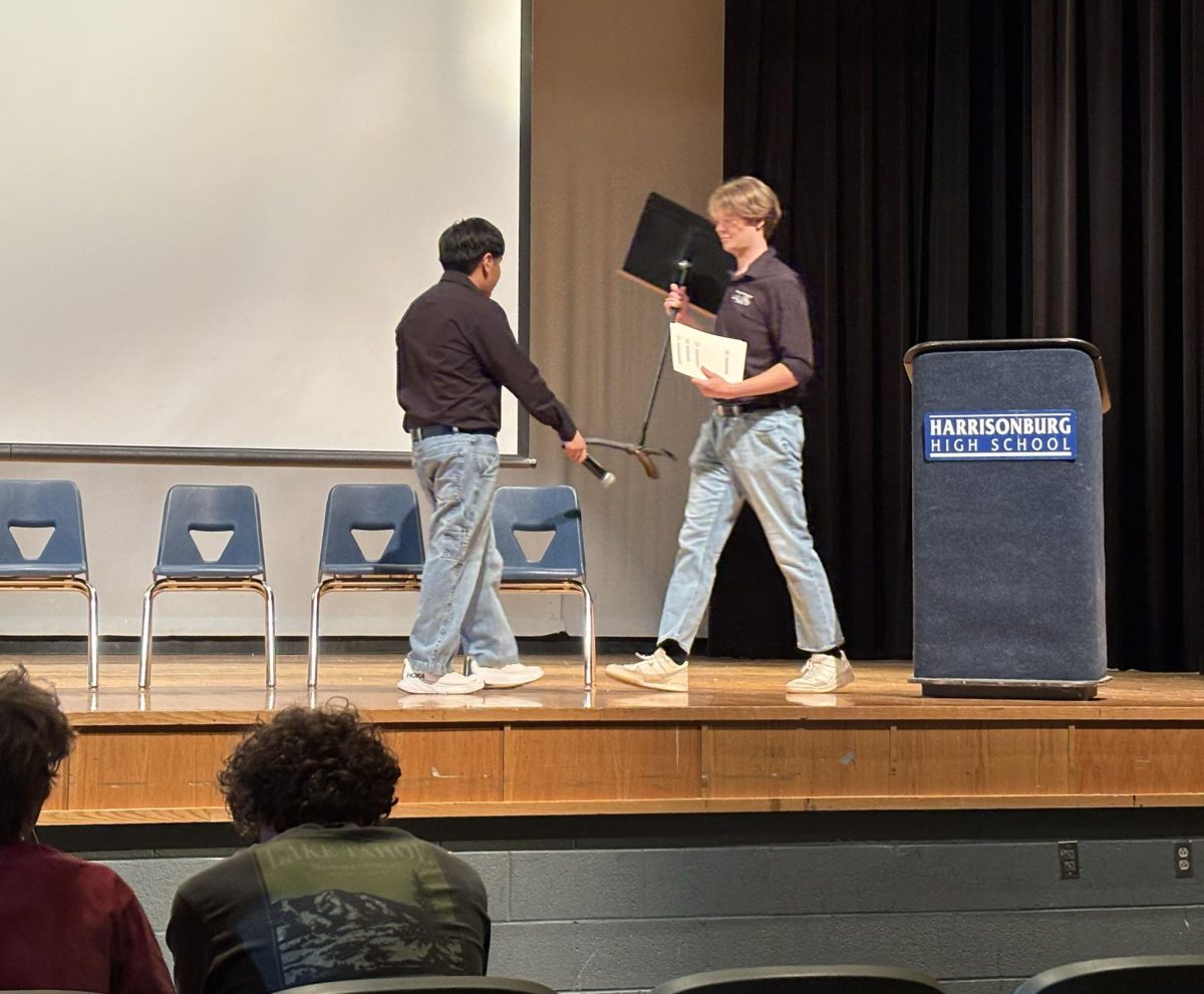 HHS Stem President Giovanni Sanchez - Garcia and Drew Lankford on the HHS auditorium stage.