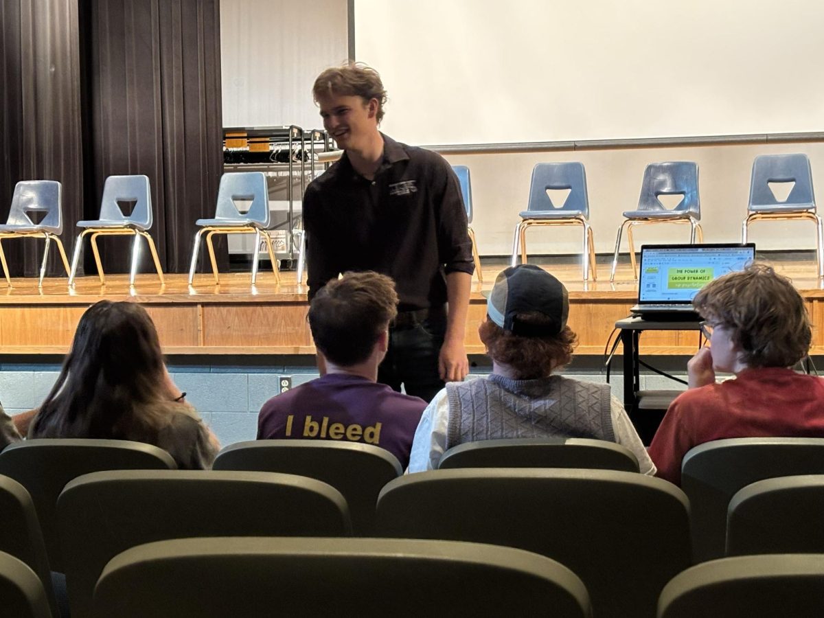 Senior Lucas Swartz talking to attendees.