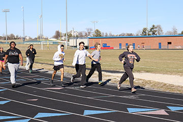 The track team on there first warmup lap.