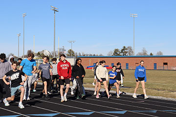 The track team doing lunges.