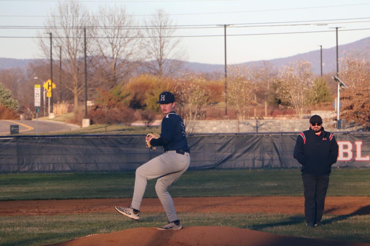 8th grader Andrew Noll throws the ball to the batter.