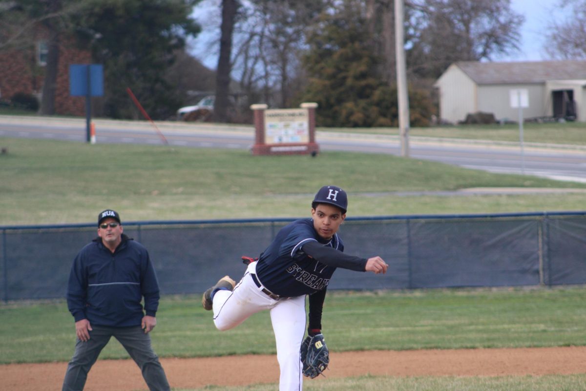 Junior Diego Pichardo Encarnation  pitches the ball over to the batter 