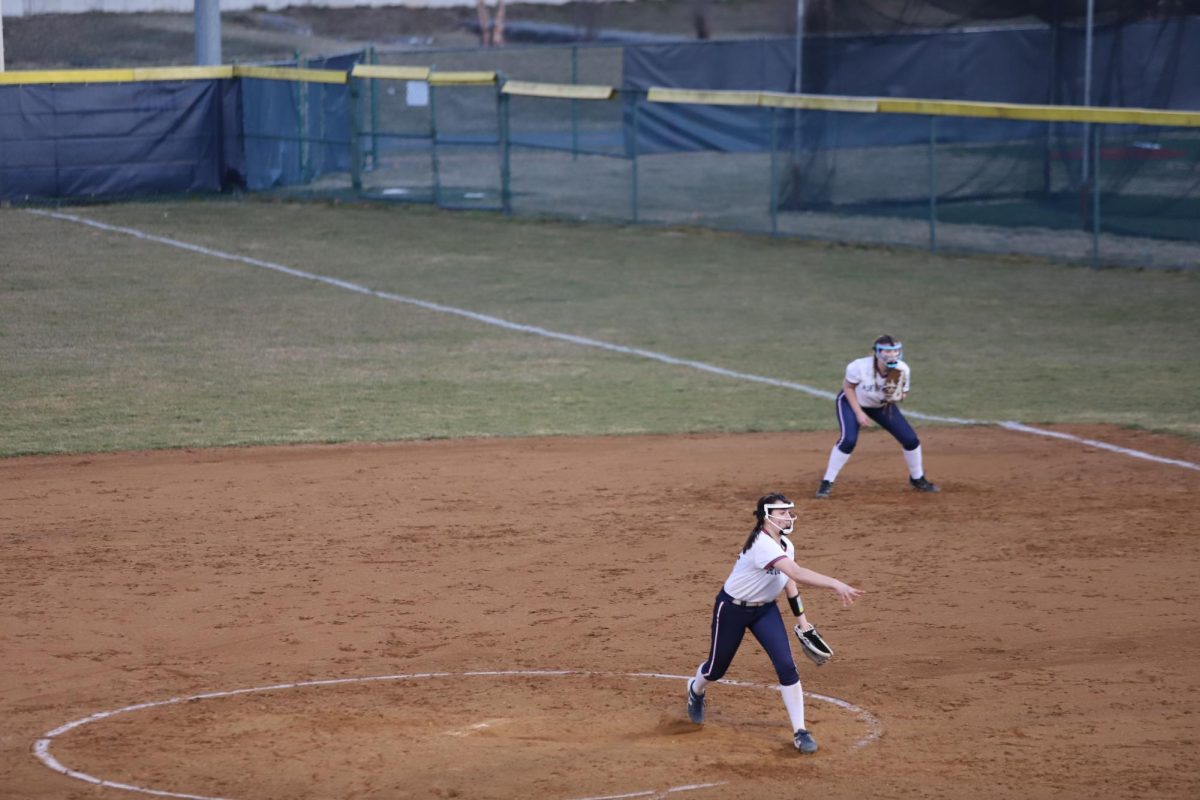 Freshman Rachel Coffman throwing the ball home.