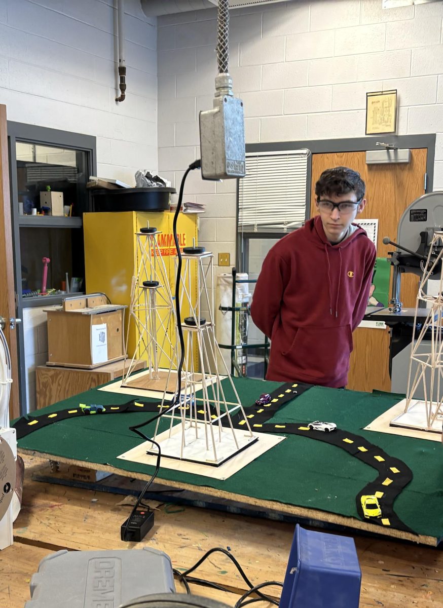 Sophomore Adrian Kreider looking at his tower being tested in "The Great Shake".