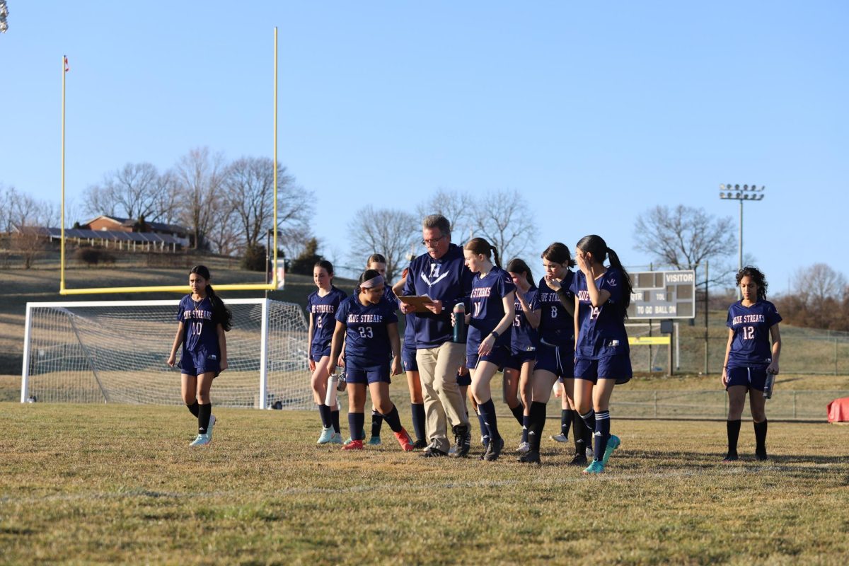 Head Coach Jeff Mumaw begins the scrimmage after speaking to soccer players.