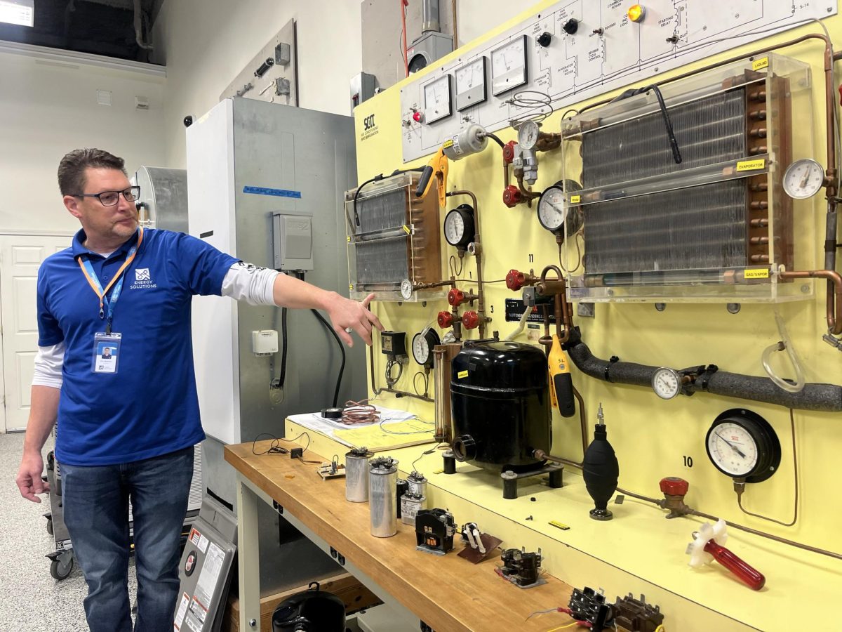 Teacher demonstrating tools for electricians 