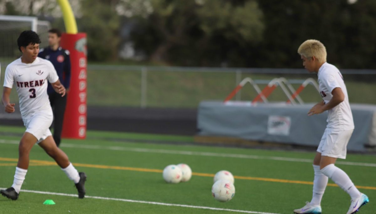 Junior Edison Rattana practicing passing the ball with freshman Alfredo Isaula Alvarez  