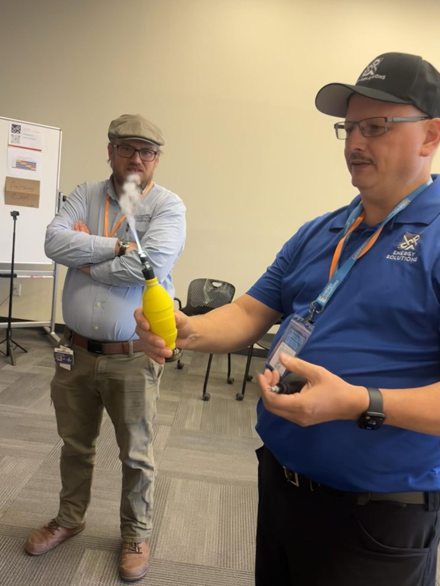 Teacher demonstrating tools that are used during installation