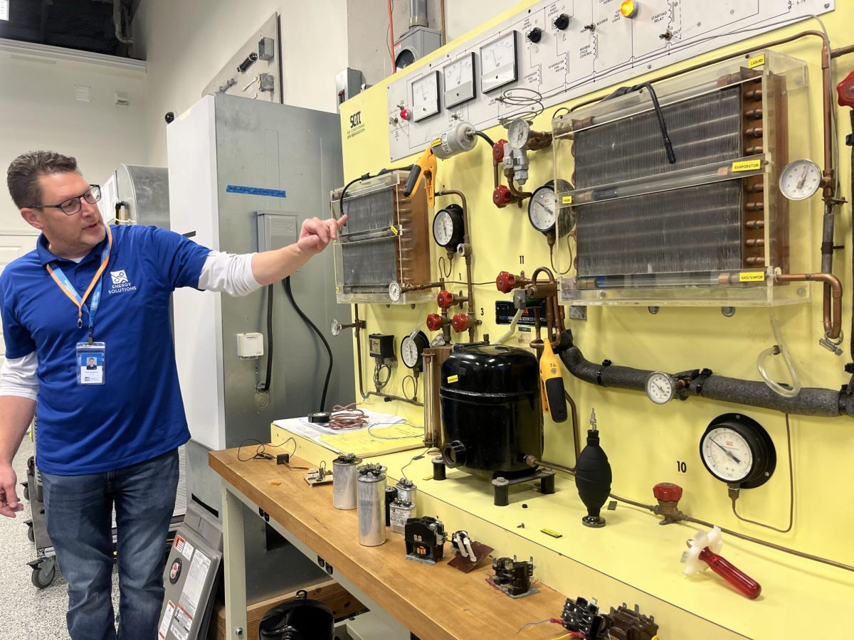 Teacher demonstrating tools for electricians 
